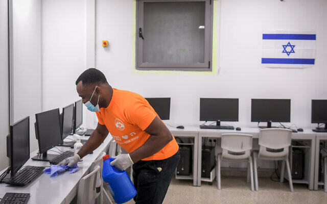 Workers clean a classroom at Luba Eliav primary school in Rishon Lezion, April 30, 2020. (Flash90) Workers clean a classroom at Luba Eliav primary school in Rishon Lezion, April 30, 2020. (Flash90)