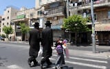 Illustrative: Ultra-OrthodoxJewish men walk in the Shmuel Hanavi  neighborhood in Jerusalem, June 6 2011. (Gili Yaari / Flash 90)