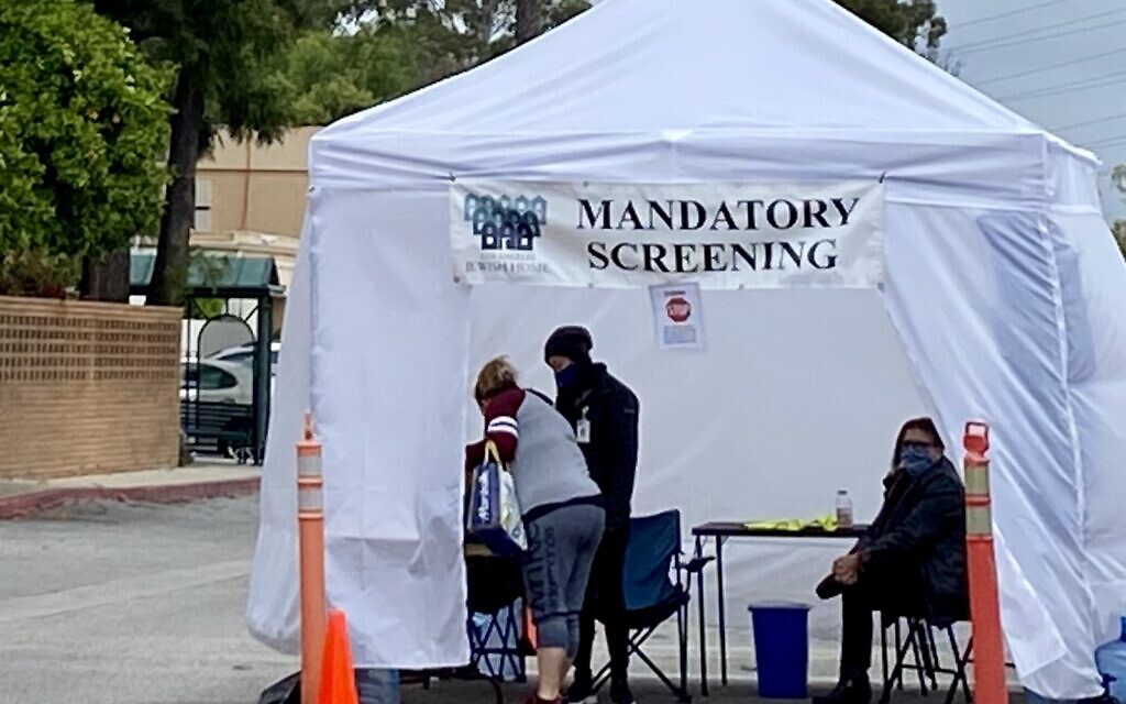 People must undergo mandatory coronavirus screening before entering the facility at the Eisenberg Village of the Los Angeles Jewish Home, April 12, 2020. (Noam Haykeen/ Times of Israel)
