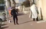 A police officer is filmed pepper-spraying a Haredi man in Netivot who was praying outside of his home on April 7, 2020. (Screen capture/TikTok)
