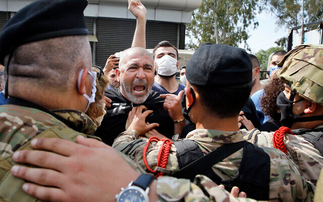Anti-government protesters scuffle with Lebanese army soldiers in the town of Zouk Mosbeh, north of Beirut, Lebanon, April 27, 2020. (AP/Bilal Hussein) Anti-government protesters scuffle with Lebanese army soldiers in the town of Zouk Mosbeh, north of Beirut, Lebanon, April 27, 2020. (AP/Bilal Hussein)