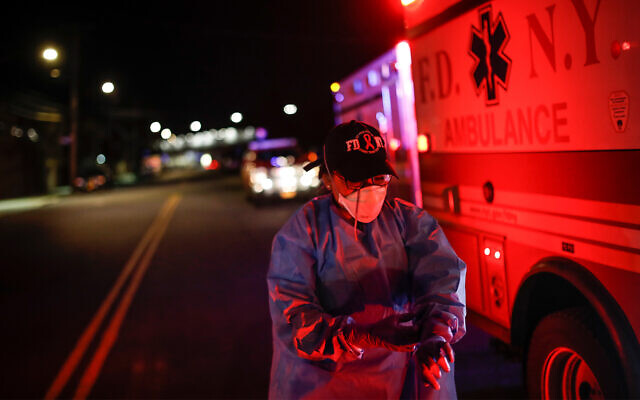 A paramedic suits up in personal protective equipment on an emergency call for a man in the Bronx, New York, April 15, 2020. (AP/John Minchillo) A paramedic suits up in personal protective equipment on an emergency call for a man in the Bronx, New York, April 15, 2020. (AP/John Minchillo)