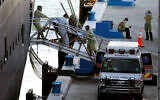 A person on a stretcher is removed from Carnival's Holland America cruise ship Zaandam at Port Everglades during the coronavirus pandemic, April 2, 2020, in Fort Lauderdale, Florida. (AP Photo/Lynne Sladky)