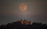 A supermoon is seen over Belvoir castle in Leicestershire, England, Tuesday, April 7, 2020. (Danny Lawson/PA via AP)