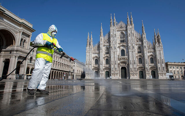 A worker sprays disinfectant to sanitize Duomo square in downtown Milan, Italy, March 31, 2020. (AP/Luca Bruno) A worker sprays disinfectant to sanitize Duomo square in downtown Milan, Italy, March 31, 2020. (AP/Luca Bruno)