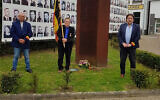 Michel Baert, right, and two commemoration activists laying a wreath at a Holocaust monument in Boortmeerbeek, Belgium on April 19, 2020. (Michel Baert via JTA)