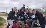 Members of Kibbutz Kfar Etzion helping get peonies ready for sale in Israel earlier this year, before many social distancing regulations took effect. (Courtesy Kibbutz Kfar Etzion)