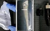An encrypted cellphone, USB device and piece of paper with a code on it that were found in the possession of an Israeli citizen suspected of spying on Israel for Iran, who was arrested on March 16, 2020. (Shin Bet)