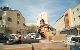 A soldier prepares to distribute food packages to residents of cities and towns hit by the coronavirus, in an undated photograph. (Israel Defense Forces)