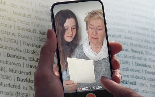 A woman and a girl read the names of Holocaust victims. (Courtesy of Yad Vashem)