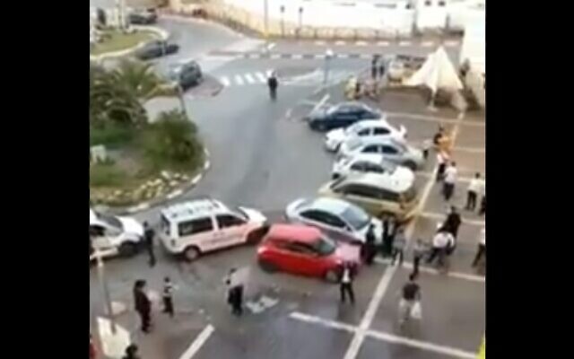 Screen capture of a brawl between residents of Modiin Illit over the Health Ministry directives on the coronavirus outbreak (via Twitter) Screen capture of a brawl between residents of Modiin Illit over the Health Ministry directives on the coronavirus outbreak (via Twitter)