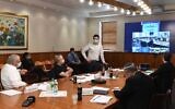 Finance Minister Moshe Kahlon (left), Health Minister director Moshe Bar Siman-Tov (standing) and other officials meet Thursday to discuss easing social distancing measures put in place to battle the coronavirus (PMO)