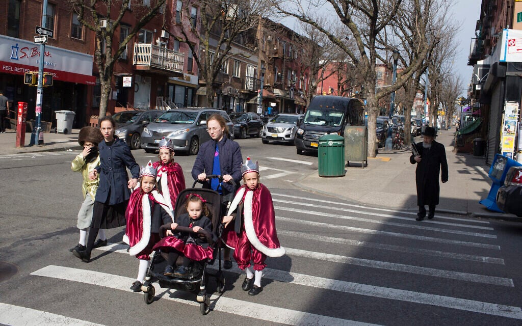 A Hasidic family, dressed up for the jewish holiday purim, crosses the street on March 10, 2020 in the Williamsburg neighborhood Brooklyn, New York. (Andrew Lichtenstein/Corbis via Getty Images via JTA) A Hasidic family, dressed up for the jewish holiday purim, crosses the street on March 10, 2020 in the Williamsburg neighborhood Brooklyn, New York. (Andrew Lichtenstein/Corbis via Getty Images via JTA)