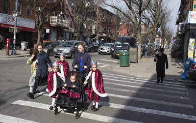A Hasidic family, dressed up for the jewish holiday purim, crosses the street on March 10, 2020 in the Williamsburg neighborhood  Brooklyn, New York. (Andrew Lichtenstein/Corbis via Getty Images via JTA)