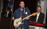 Adam Sandler playing at a benefit concert in Los Angeles, March 3, 2018. His latest standup special has received warm reviews. (Jerritt Clark/Getty Images for Artists for Peace and Justice via JTA)