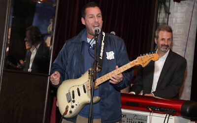 Adam Sandler playing at a benefit concert in Los Angeles, March 3, 2018. His latest standup special has received warm reviews. (Jerritt Clark/Getty Images for Artists for Peace and Justice via JTA)