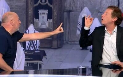 Harel Wiesel, left, and Avi Simhon arguing in the Channel 12 studio on April 13, 2020. (Screen capture: Channel 12)