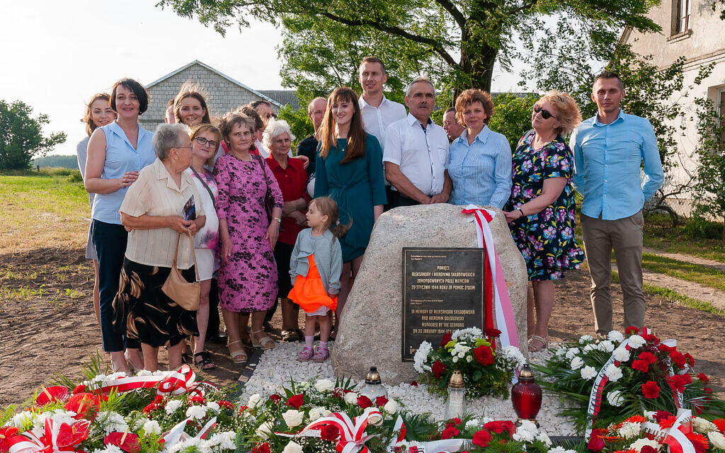 A Polish family at a memorial honoring their relatives who tried to rescue Jews during World War II. (Courtesy Pilecki Institute)