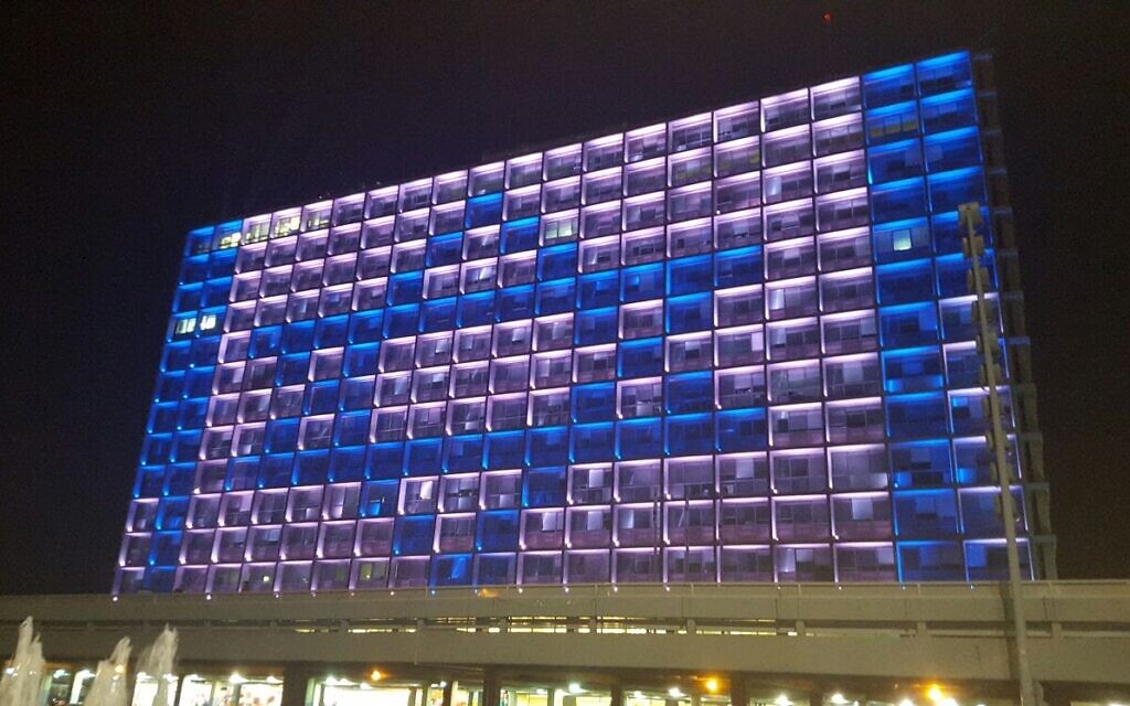 Tel Aviv's City Hall will be lit up for this year's Yom Ha'atzmaut celebration on April 28, 2020, which will eschew fireworks and parades for a more modest festivities in honor of Israel's 72nd year of independence. (courtesy, City of Tel Aviv-Jaffa) Tel Aviv's City Hall will be lit up for this year's Yom Ha'atzmaut celebration on April 28, 2020, which will eschew fireworks and parades for a more modest festivities in honor of Israel's 72nd year of independence. (courtesy, City of Tel Aviv-Jaffa)
