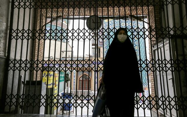 A woman walks past the closed gate outside the Imamzadeh Saleh in the Iranian capital Tehran's Shemiran district on April 25, 2020, during the Muslim holy month of Ramadan, as all mosques and places of worship are closed due to the COVID-19 coronavirus pandemic. (ATTA KENARE / AFP) A woman walks past the closed gate outside the Imamzadeh Saleh in the Iranian capital Tehran's Shemiran district on April 25, 2020, during the Muslim holy month of Ramadan, as all mosques and places of worship are closed due to the COVID-19 coronavirus pandemic. (ATTA KENARE / AFP)