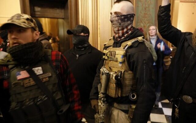 Right-wing protestors trying to enter the Michigan House of Representative chamber are kept out by the Michigan State Police at the Michigan State Capitol in Lansing, Michigan, April 30, 2020. (Jeff Kowalsky/AFP) Right-wing protestors trying to enter the Michigan House of Representative chamber are kept out by the Michigan State Police at the Michigan State Capitol in Lansing, Michigan, April 30, 2020. (Jeff Kowalsky/AFP)