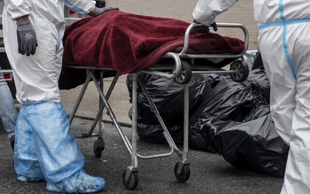 Medical workers in hazmat suits transport a body on a stretcher outside a funeral home in the New York City borough of Brooklyn on April 30, 2020. (Johannes Eisele/AFP) Medical workers in hazmat suits transport a body on a stretcher outside a funeral home in the New York City borough of Brooklyn on April 30, 2020. (Johannes Eisele/AFP)