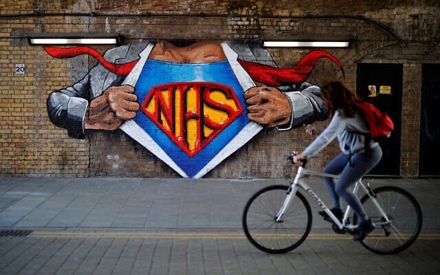 A cyclist passes artwork celebrating the National Health Service (NHS) in central London, May 5, 2020, during the nationwide lockdown due to the novel coronavirus COVID-19 outbreak. (Tolga Akmen/AFP) A cyclist passes artwork celebrating the National Health Service (NHS) in central London, May 5, 2020, during the nationwide lockdown due to the novel coronavirus COVID-19 outbreak. (Tolga Akmen/AFP)