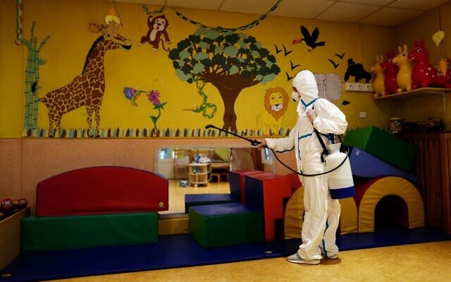 A member of a desinfection squad cleans a nursery in the French Riviera city of Cannes, southern France, on May 6, 2020, as the nurseries in France are to gradually reopen from May 11, when a partial lifting of restrictions due to the Covid-19 pandemic caused by the novel coronavirus comes into effect. (Valery Hache/AFP) A member of a desinfection squad cleans a nursery in the French Riviera city of Cannes, southern France, on May 6, 2020, as the nurseries in France are to gradually reopen from May 11, when a partial lifting of restrictions due to the Covid-19 pandemic caused by the novel coronavirus comes into effect. (Valery Hache/AFP)
