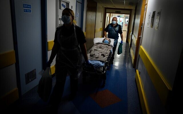 File: An ambulance crew moves an elderly patient from hospital to a care home on May 5, 2020 near Portsmouth, southwest England. (Leon Neal/Pool/AFP) File: An ambulance crew moves an elderly patient from hospital to a care home on May 5, 2020 near Portsmouth, southwest England. (Leon Neal/Pool/AFP)