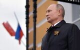 Russian President Vladimir Putin looks at military aircraft flying over the Kremlin and Red Square to mark the 75th anniversary of the victory over Nazi Germany in World War II, Moscow, May 9, 2020. (Alexey DRUZHININ / SPUTNIK / AFP)