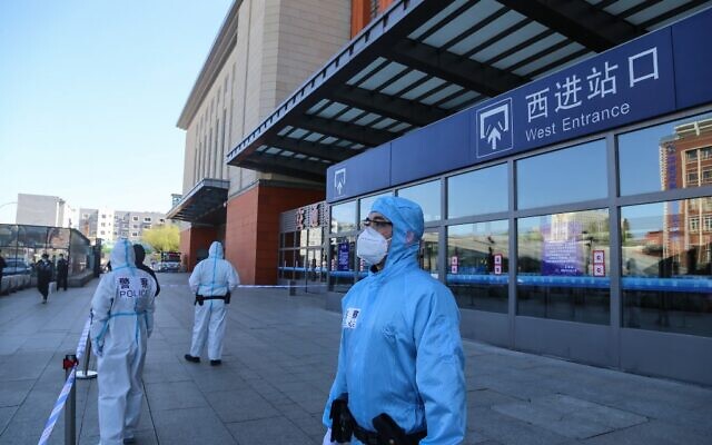 Police officers clad in protective suits stand guard outside Jilin city's railway station in China's Jilin province on May 13, 2020. (Photo by STR / AFP) Police officers clad in protective suits stand guard outside Jilin city's railway station in China's Jilin province on May 13, 2020. (Photo by STR / AFP)