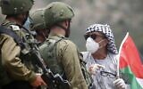 A Palestinian confronts IDF soldiers during a demonstration against Israeli settlements in the northern West Bank village of al-Sawiya on May 15, 2020, as Palestinians mark Nakba Day, or the 'catastrophe' of the displacement of Palestinians in the war during Israel's founding. (Jaafar Ashtiyeh/AFP)