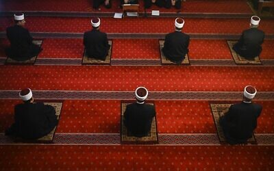 Imams observe social distance rules as they attend the Eid al-Fitr prayers, at the Grand Mosque in Pristina on May 24, 2020 (Armend NIMANI / AFP)