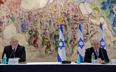 Prime Minister Benjamin Netanyahu (R) and Defense Minister Benny Gantz (L) attend a cabinet meeting of the new government at Chagall State Hall in the Knesset in Jerusalem on May 24, 2020. (Abir Sultan/Pool/AFP)