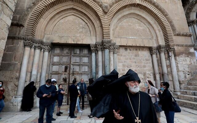 Disappointed visitors and worshipers gather in front of the shut doors of the Church of the Holy Sepulchre in Jerusalem's Old City on May 24, 2020, closed due to the COVID-19 pandemic lockdown. (GALI TIBBON / AFP) Disappointed visitors and worshipers gather in front of the shut doors of the Church of the Holy Sepulchre in Jerusalem's Old City on May 24, 2020, closed due to the COVID-19 pandemic lockdown. (GALI TIBBON / AFP)