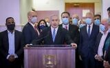 Prime Minister Benjamin Netanyahu delivers a statement before entering a courtroom at the Jerusalem District Court on May 24, 2020, for the start of his corruption trial. Among those alongside him from left are Likud MKs and ministers Gadi Yevarkan, Amir Ohana, Miri Regev, Nir Barkat, Israel Katz, Tzachi Hanegbi, Yoav Gallant and David Amsalem. (Yonathan Sindel/Pool/AFP)
