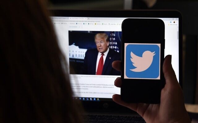 In this photo illustration, a Twitter logo is displayed on a mobile phone with President Trump's Twitter page shown in the background on May 27, 2020, in Arlington, Virginia. (Olivier DOULIERY / AFP) In this photo illustration, a Twitter logo is displayed on a mobile phone with President Trump's Twitter page shown in the background on May 27, 2020, in Arlington, Virginia. (Olivier DOULIERY / AFP)