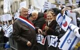 In this file photo taken on January 15, 2017, the Mayor of the 16th arrondissement Claude Goasguen greets protestors as they demonstrate during a rally in Paris against the Paris Middle East peace conference taking place in the French capital. (Photo by Pierre Constant/ AFP)