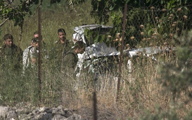 Israeli soldiers inspect a car at the scene of an apparent attempted car-ramming attack near the West Bank settlement of Halamish on May 29, 2020. (Abbas Momani/AFP) Israeli soldiers inspect a car at the scene of an apparent attempted car-ramming attack near the West Bank settlement of Halamish on May 29, 2020. (Abbas Momani/AFP)