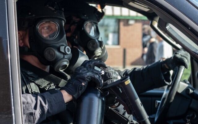 Detroit Police in riot gear sit in a police SUV during a demonstration in Detroit, Michigan, on May 29, 2020 over the death of George Floyd, a black man who died after a white policeman kneeled on his neck for several minutes (Seth HERALD / AFP)