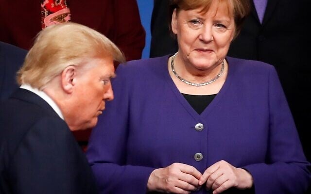 In this file photo taken on December 04, 2019 Germany's Chancellor Angela Merkel (R) looks at US President Donald Trump walking past her during a group photo as part of the NATO summit at the Grove hotel in Watford, northeast of London (CHRISTIAN HARTMANN / POOL / AFP) In this file photo taken on December 04, 2019 Germany's Chancellor Angela Merkel (R) looks at US President Donald Trump walking past her during a group photo as part of the NATO summit at the Grove hotel in Watford, northeast of London (CHRISTIAN HARTMANN / POOL / AFP)