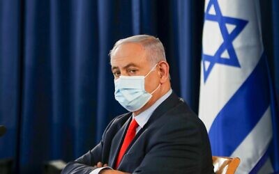Prime Minister Benjamin Netanyahu, wearing a protective face mask, chairs the weekly cabinet meeting in Jerusalem on May 31, 2020. (Ronen Zvulun/ Pool/ AFP)