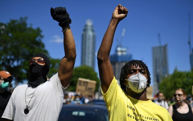 Demonstrators make black power salutes as they make their way toward the US Embassy in central London on May 31, 2020, to protest the death of George Floyd, an unarmed black man who died after a police officer knelt on his neck for nearly nine minutes during an arrest in Minneapolis, Minnesota USA. (DANIEL LEAL-OLIVAS / AFP) Demonstrators make black power salutes as they make their way toward the US Embassy in central London on May 31, 2020, to protest the death of George Floyd, an unarmed black man who died after a police officer knelt on his neck for nearly nine minutes during an arrest in Minneapolis, Minnesota USA. (DANIEL LEAL-OLIVAS / AFP)