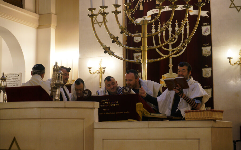 Rabbi Michael Azoulay, second from right, reading the Torah with congregants at the synagogue of Neuilly-sur-Seine, a Paris suburb, Dec. 11, 2017. (Cnaan Liphshiz/JTA) Rabbi Michael Azoulay, second from right, reading the Torah with congregants at the synagogue of Neuilly-sur-Seine, a Paris suburb, Dec. 11, 2017. (Cnaan Liphshiz/JTA)