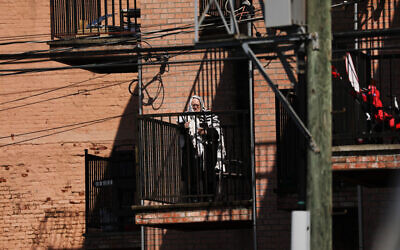 A Hasidic man prays on his balcony in a Brooklyn neighborhood on April 25, 2020 in New York City. (Spencer Platt/Getty Images via JTA)