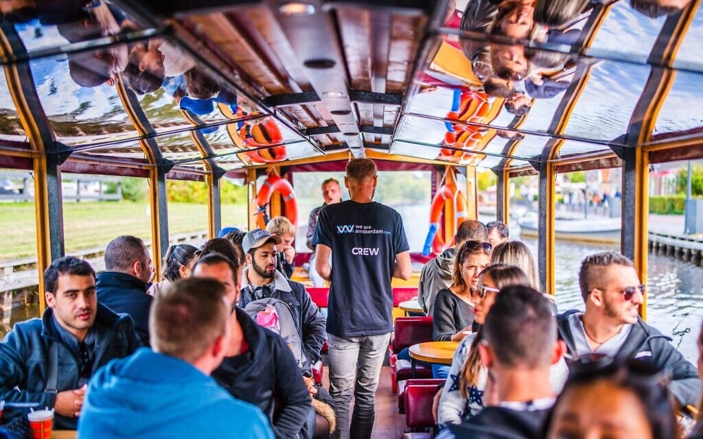 A boat belonging to the We Are Amsterdam canal tour sails in 2019. (Courtesy of We Are Amsterdam/ via JTA)