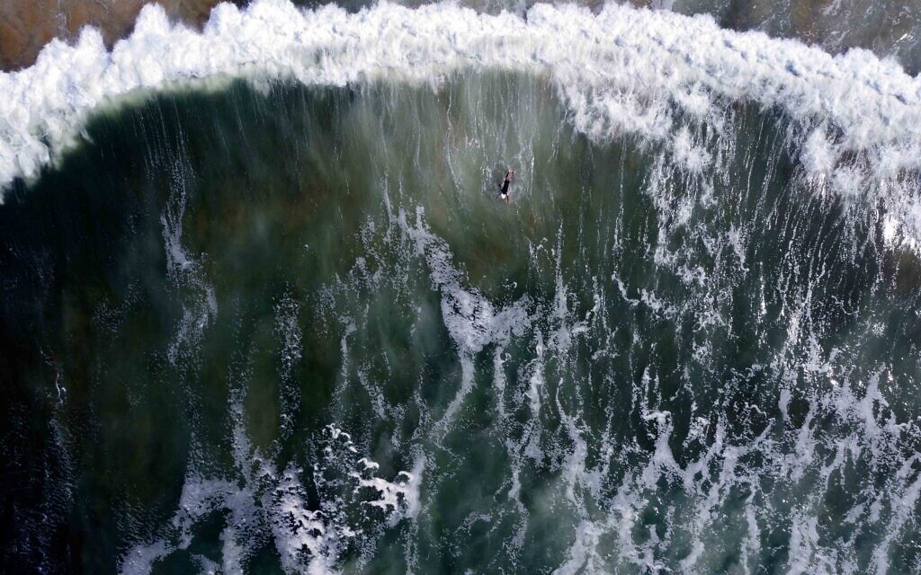 A lone surfer at Hilton Beach, Tel Aviv, March 2020. (Photo by Lord K2)