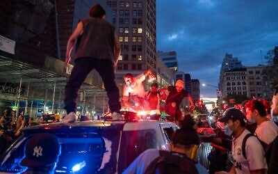 Protesters vandalize a police cruiser in Union Square on May 30, 2020, in New York City (David Dee Delgado/Getty Images/AFP)