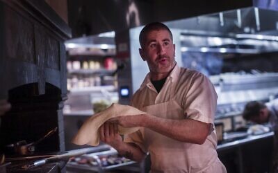 Award winning Chef Michael Solomonov, left, works the oven and the line at his restaurant Zahav in Philadelphia, Pennsylvania, on July 14, 2015. (Melina Mara/The Washington Post via JTA)