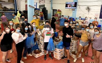 Year Course students this spring wear masks while volunteering. (Courtesy of Year Course/ via JTA)